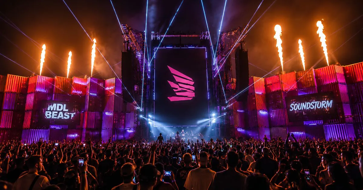 Crowd facing a large illuminated concert stage at night in Riyadh